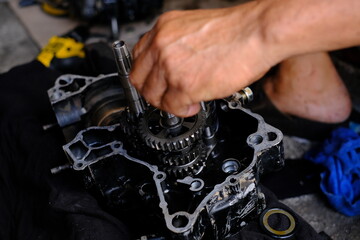 Obraz na płótnie Canvas Maintenance, repair of the motorcycle engine gear system