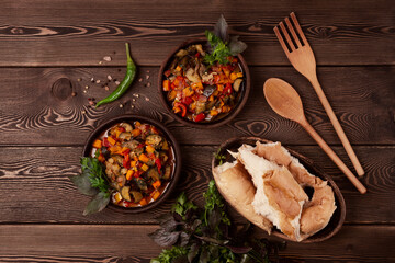 Georgian cuisine, Ajapsandal, stewed vegetables, on a wooden table, rustic, horizontal, no people,
