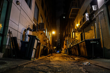 Fototapeta na wymiar dark urban alleyway with dim lights in the city