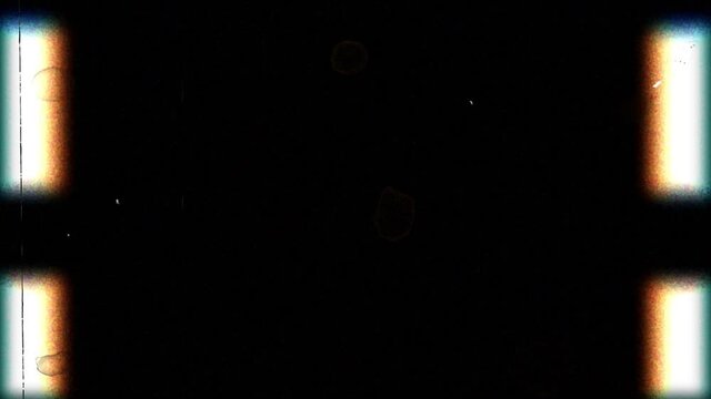 In front of the camera, old film passes from top to bottom, but it is spoiled and nothing is visible except interference.