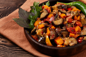 Georgian cuisine, Ajapsandal, stewed vegetables, on a wooden table, rustic, horizontal, no people,