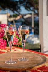 Romantic wedding party with two glasses of white cold champagne and view on yachts and houses of Port Grimaud, French riviera, France