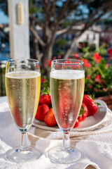 Summer party, pouring of French champagne sparkling wine in glasses in yacht harbour of Port Grimaud near Saint-Tropez, French Riviera vacation, France