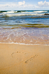 one heart drawn on the sand