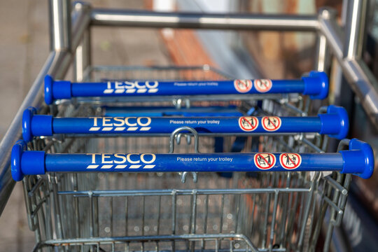 08/02/2020 Portsmouth, Hampshire, UK A close up of the handles of Tesco shopping trolleys or shopping carts in a trolley park shot using selective focus