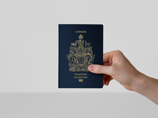 hand holding Canada passport