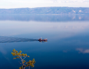 View of Lake Baikal in the early summer morning. Olkhon Island. Ship on the lake.