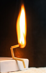 Concept of weakness, sadness, and loneliness. Image of a man-made matchstick. Burning matchstick...