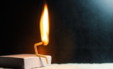 Concept of weakness, sadness, and loneliness. Image of a man-made matchstick. Burning matchstick...