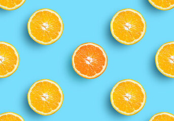Orange fruit slice on soft pastel blue background. Lemon fruit, citrus minimal concept, vitamin C. Creative summer minimalistic background. Top view