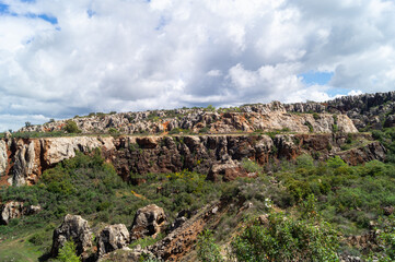 Cerro del Hierro natural monument in the Sierra del Norte de Sevilla natural park (San Nicolas del Puerto, Andalusia). Open pit mining deposits characterized by the color of the limestone rock. - obrazy, fototapety, plakaty