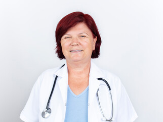 Fototapeta premium Senior female doctor. Portrait of beautiful mature female doctor looking at camera. Medical concept