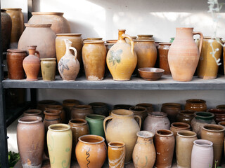 Fototapeta na wymiar Сeramic pots and vases. Handmade. Pottery on the shelves in the workshop