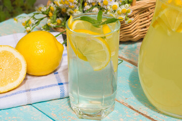 Two glasses of homemade lemonade on a rustic wooden background