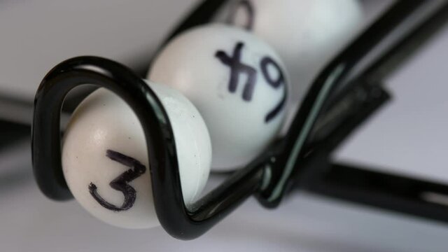 Close-up of a lottery or Bingo ball catcher as the winning numbers roll out.