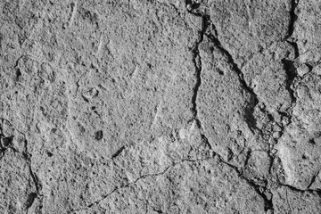 The texture of cracked concrete. Gray broken concrete. The background is made of concrete.