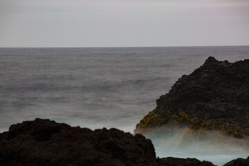 Vulcanic landscape of basalt rock meets the sea at Ponta da Ferraria on the island of Sao Miguel, Azores.