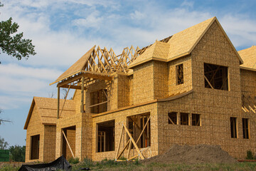 Different views of spacious 2 story wood frame luxury home under construction.