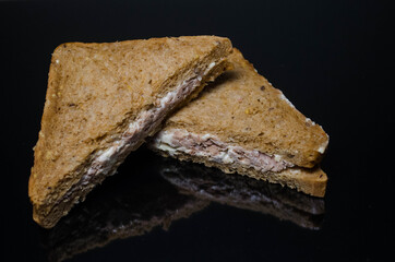 Tuna sandwich, photo on a dark surface