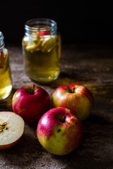 Naklejka na ściany i meble A refreshing jug of apple cider on wood table
