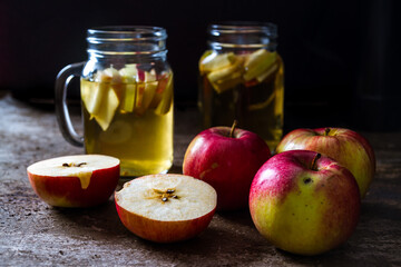 A refreshing jug of apple cider on wood table