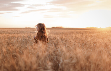 portrait of girl in a field with wheat