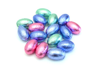 Chocolate easter eggs in colorful foil on white background