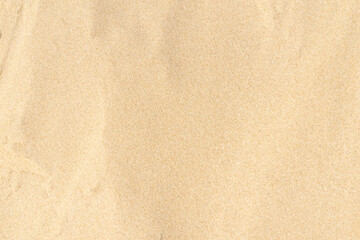 Fototapeta na wymiar Sand pattern texture in tropical beach. Brown sand for background.