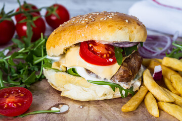 Homemade Beef Burger with Cheese and Chips on wooden background
