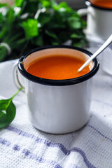 Carrot soup on a table in mugs. Homemade healty food