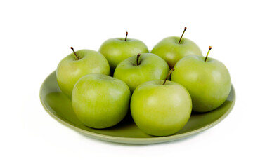 green apples on a plate of isolate