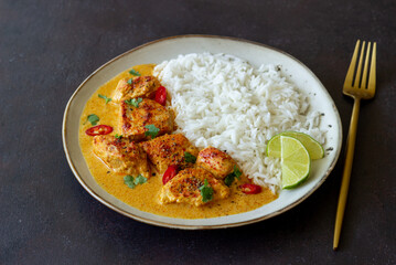 Chicken tikka masala curry with rice, herbs and peppers. Indian food. National cuisine.