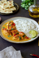 Chicken tikka masala curry with rice, herbs and peppers. Indian food. National cuisine.
