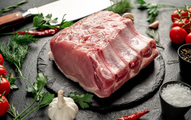 Raw whole pork steaks with ribs on stone background