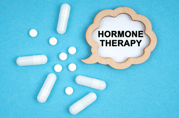 On a blue background, pills and a plate, inside which the inscription - Hormone therapy