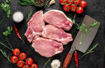 Raw pork steaks with ribs on stone background
