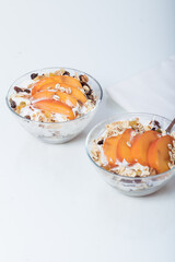 Homemade vegan granola cereal with soy yogurt, walnuts, fuji apple and almond milk.