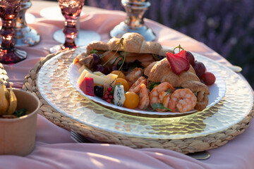 Preparing a romantic dinner in lavender field. St.Valentines Day.