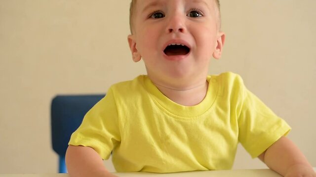 baby boy in yellow shirt crying. the kid is naughty.