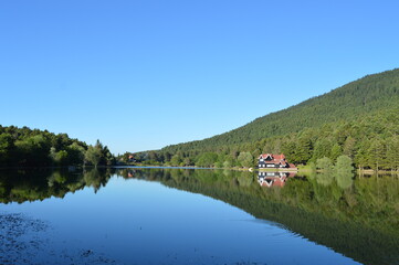 House on the lake in Bolu Gölcük National Park, reflection of trees and  house on lake