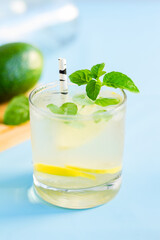 Homemade mojito cocktail on blue background