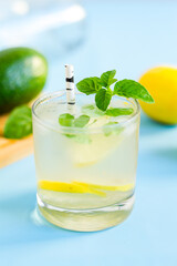 Homemade mojito cocktail on blue background