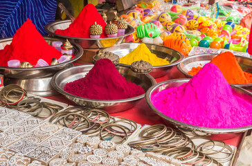 Stamps, bracelets and color powder at a market stall in Orchha