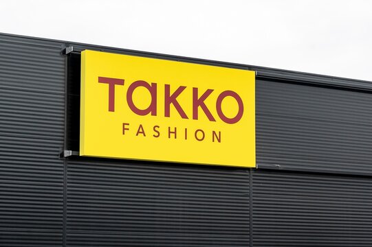 The yellow banner of Takko Fashion company above its department store