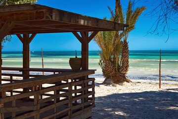 Beautiful views of the Mediterranean coast with birch water, white sand beach and bungalows on the shore