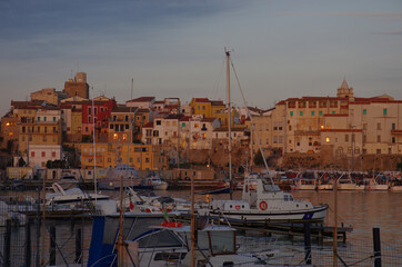 Termoli: The light of dawn illuminates the houses overlooking the port..