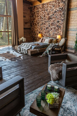 dark cozy interior of big country wooden house, wooden furniture and animal furs. huge panoramic...