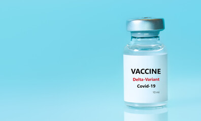 Bottle of Covid-19 vaccine to immunize from the Delta Variant Coronavirus on blue background. The concept of medicine, healthcare and science.Copy space for text.