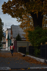 Girl walks around the city in autumn