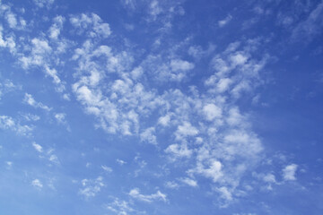 View of the blue sky with white clouds in sunny weather.
